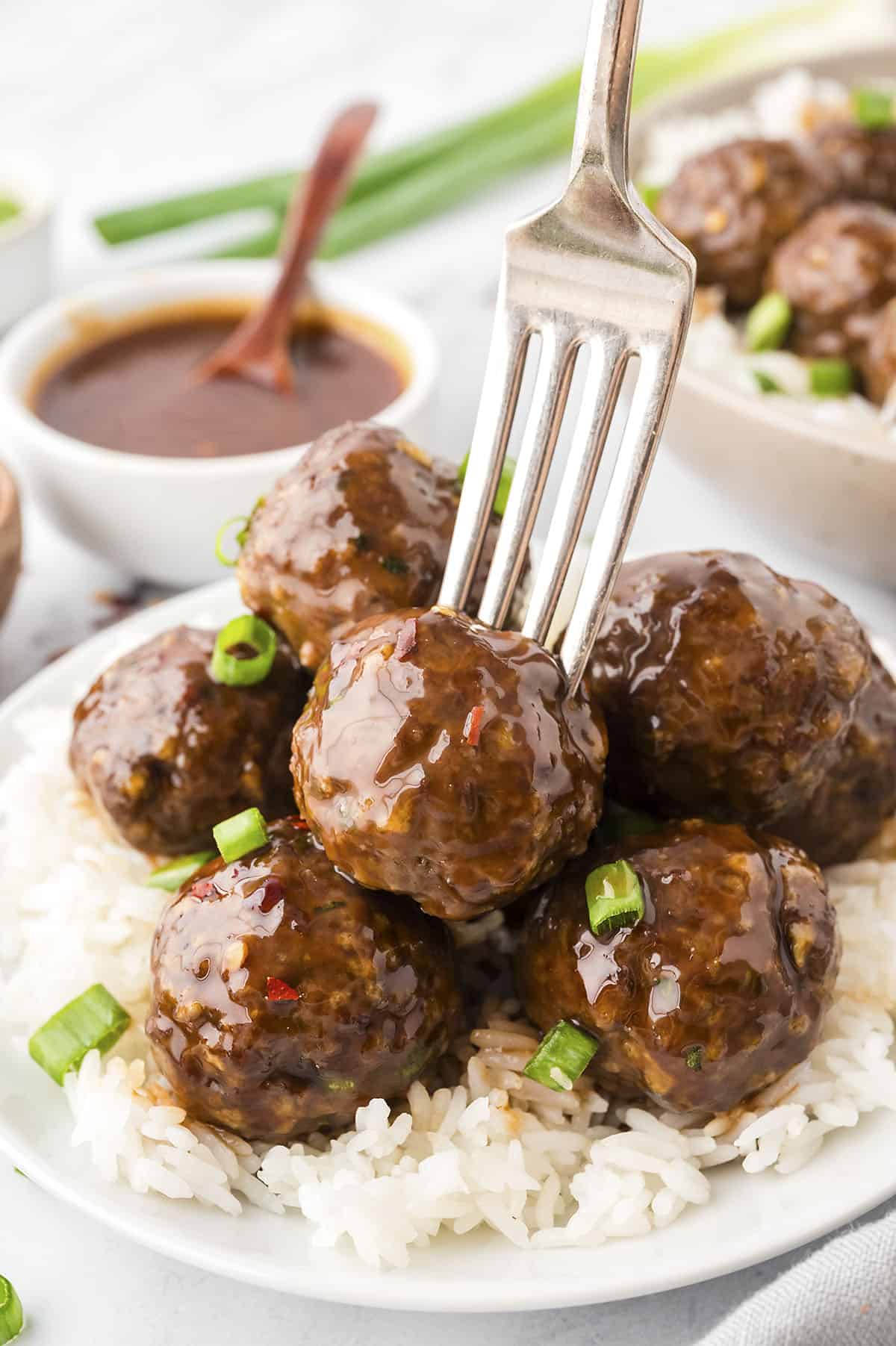 Fork grabbing a firecracker meatball.