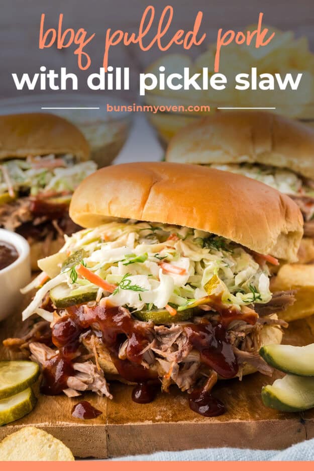 Puled pork sandwich topped with slaw and pickles.