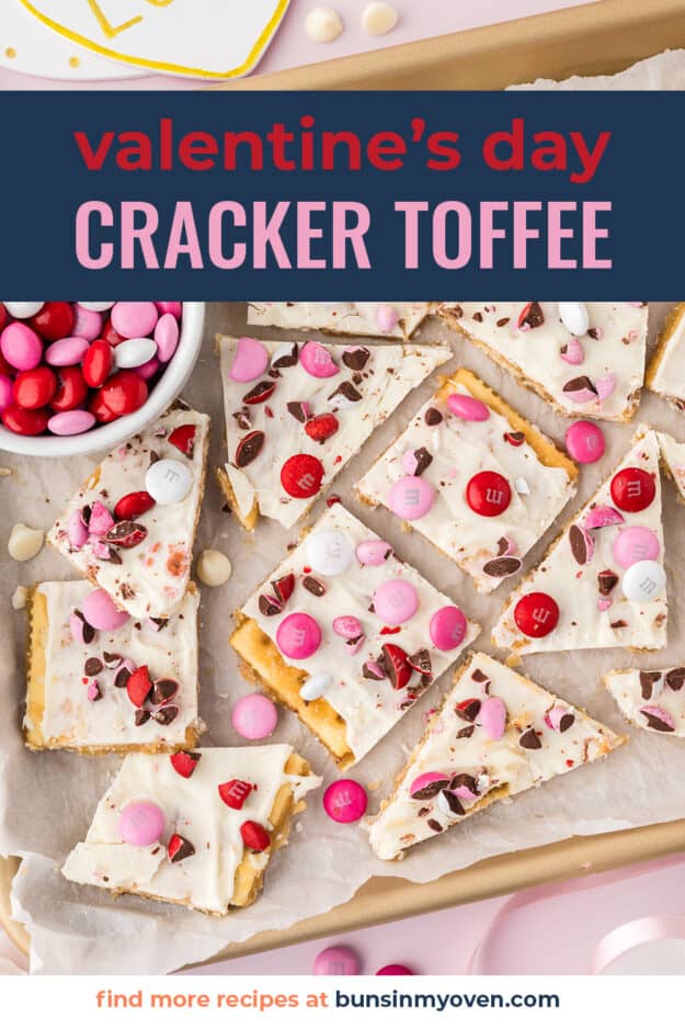 Cracker toffee with red and pink m&m candies on sheet pan.