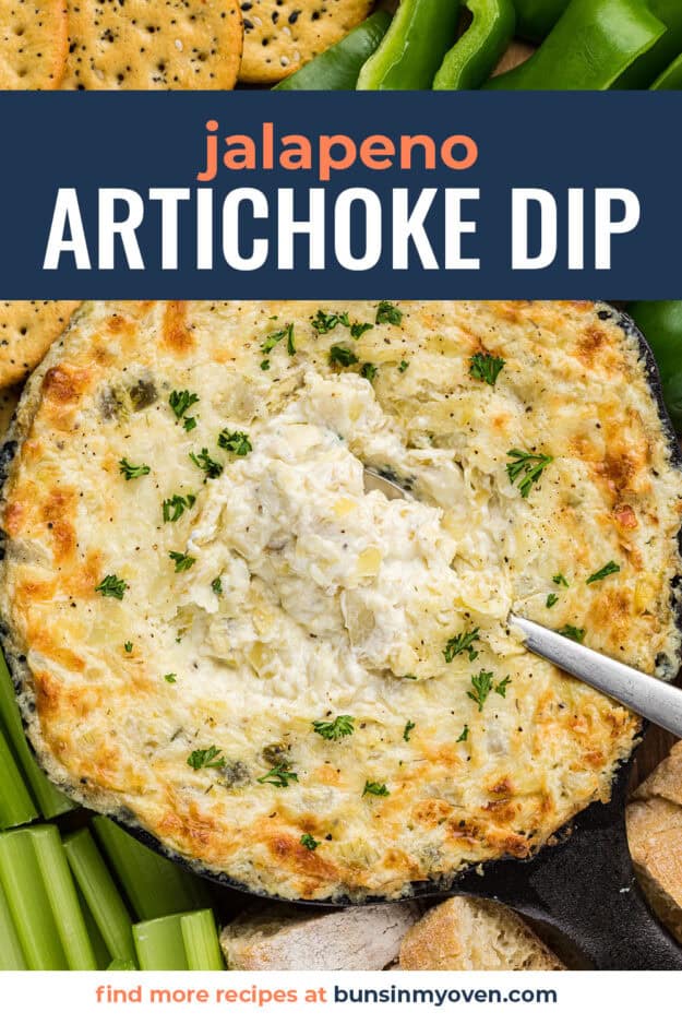 Cast iron skillet full of artichoke dip with jalapeños.